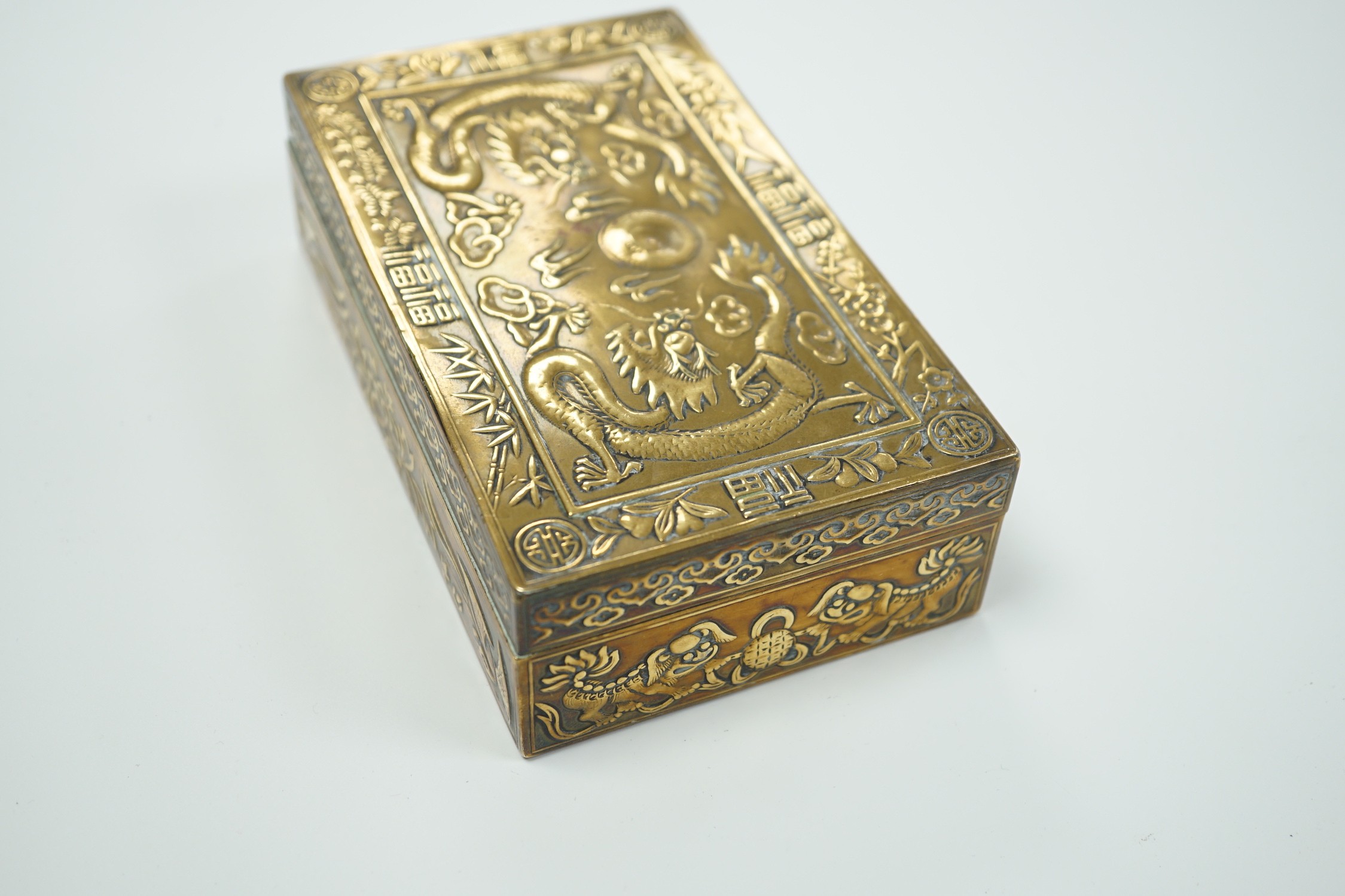 A Chinese brass 'dragon' cigarette box, 15.5cm